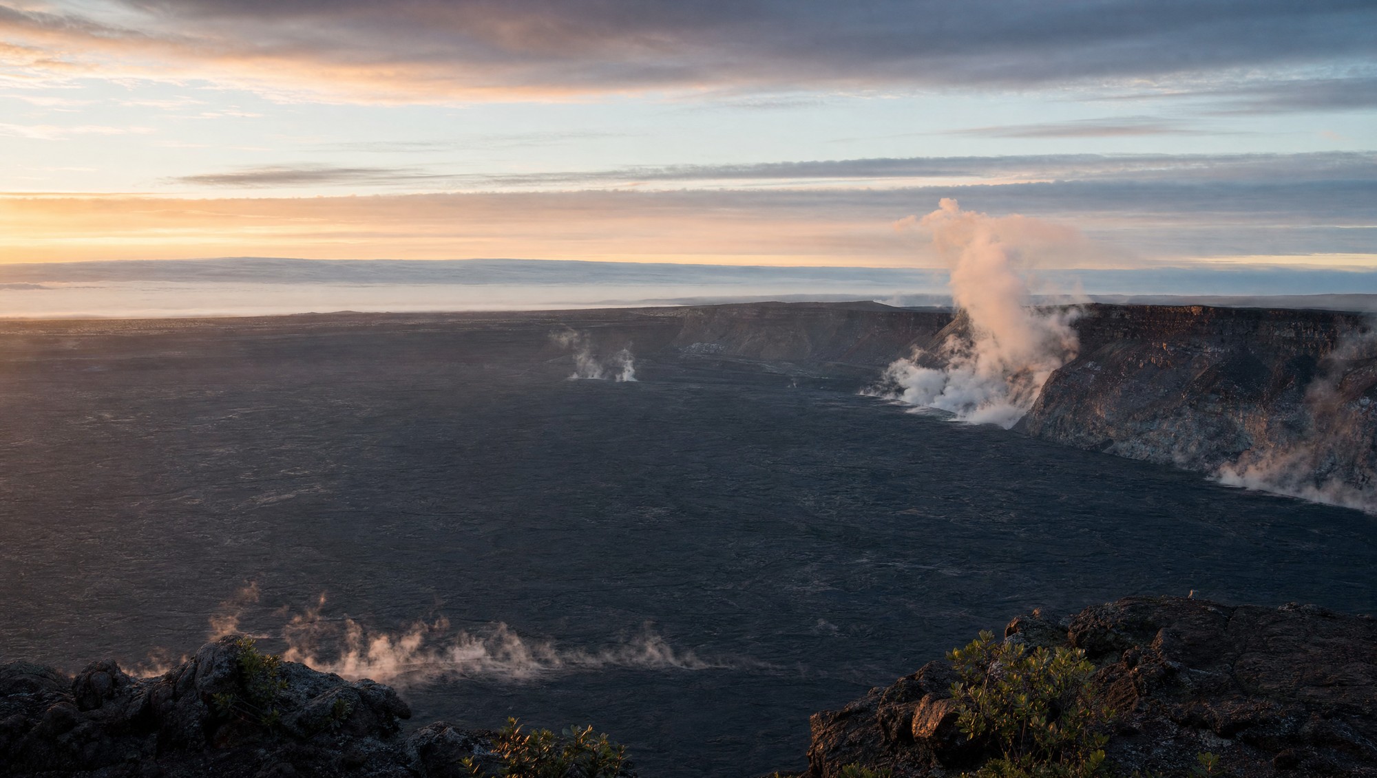 Halemaʻumaʻu crater at Kīlauea at first light, steam rising from the caldera floor